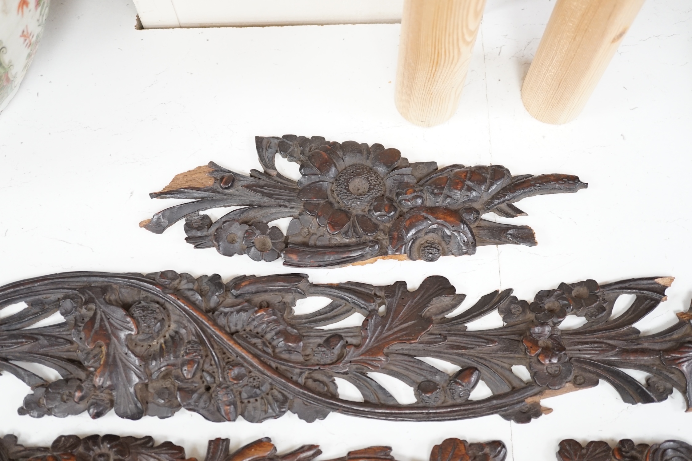 A carved walnut frieze and section with floral decoration, 131cm long. Condition - poor to fair, broken into sections and some woodworm